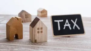 Image showing model wooden houses with a blackboard with the words Tax written on it depicting LBTT