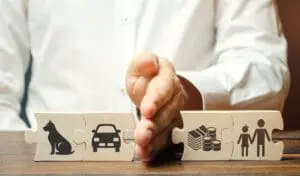 Image of a jigsaw pieces showing family property being cut in half by a man's hand to depict the advantages of having a separation agreement