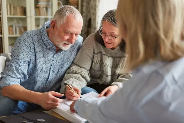 Elderly couple meeting with their lawyer to sign a Power of Attorney
