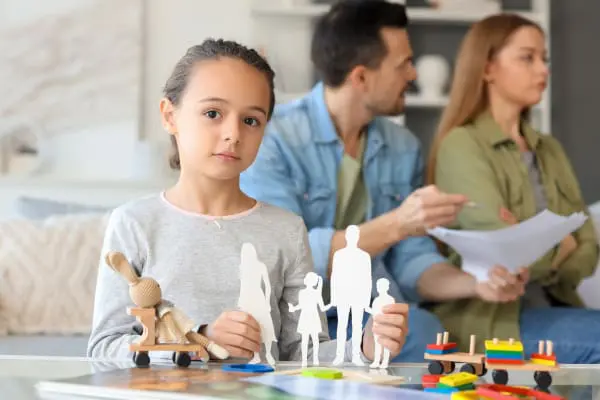 Child listening to her parents arguing over residence and contact for children